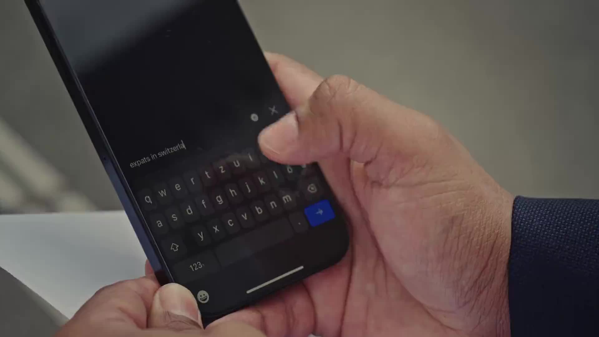 A hand typing "expats in Switzerland" into a phone, moments before the first advisory meeting